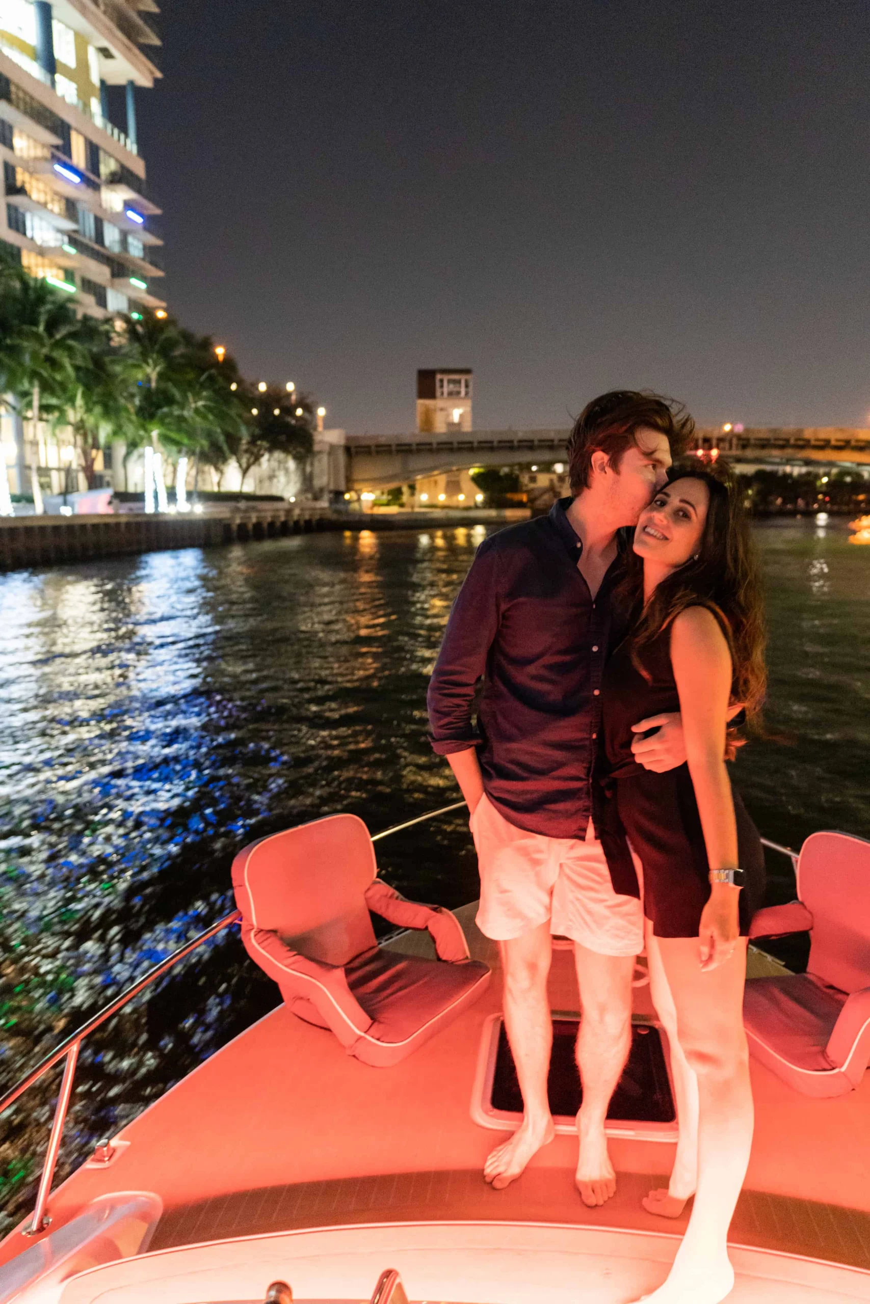 Couple on the bow of the boat at night in Miami
