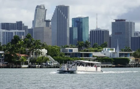 Aqua Party Boat on Biscayne Bay with Downtown Miami skyline and waterfront mansions — architecture and design cruise